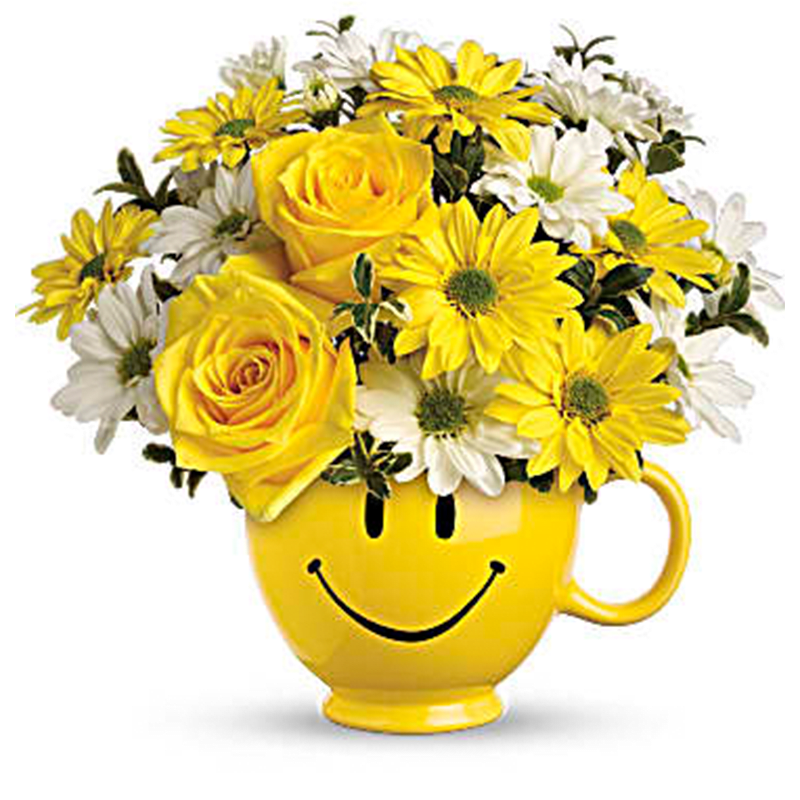 Be Happy Mug - Be Happy Mug is a cheerful, feel-good arrangement designed to spark instant smiles. Bright blooms are gathered inside an iconic yellow smiley mug, creating a playful and uplifting design that feels lighthearted and full of joy. With its sunny personality and friendly charm, this arrangement is all about spreading happiness in the simplest, sweetest way.  Perfect for get well wishes, birthdays, or just because, Be Happy Mug is a delightful way to brighten someone’s day and lift their spirits.