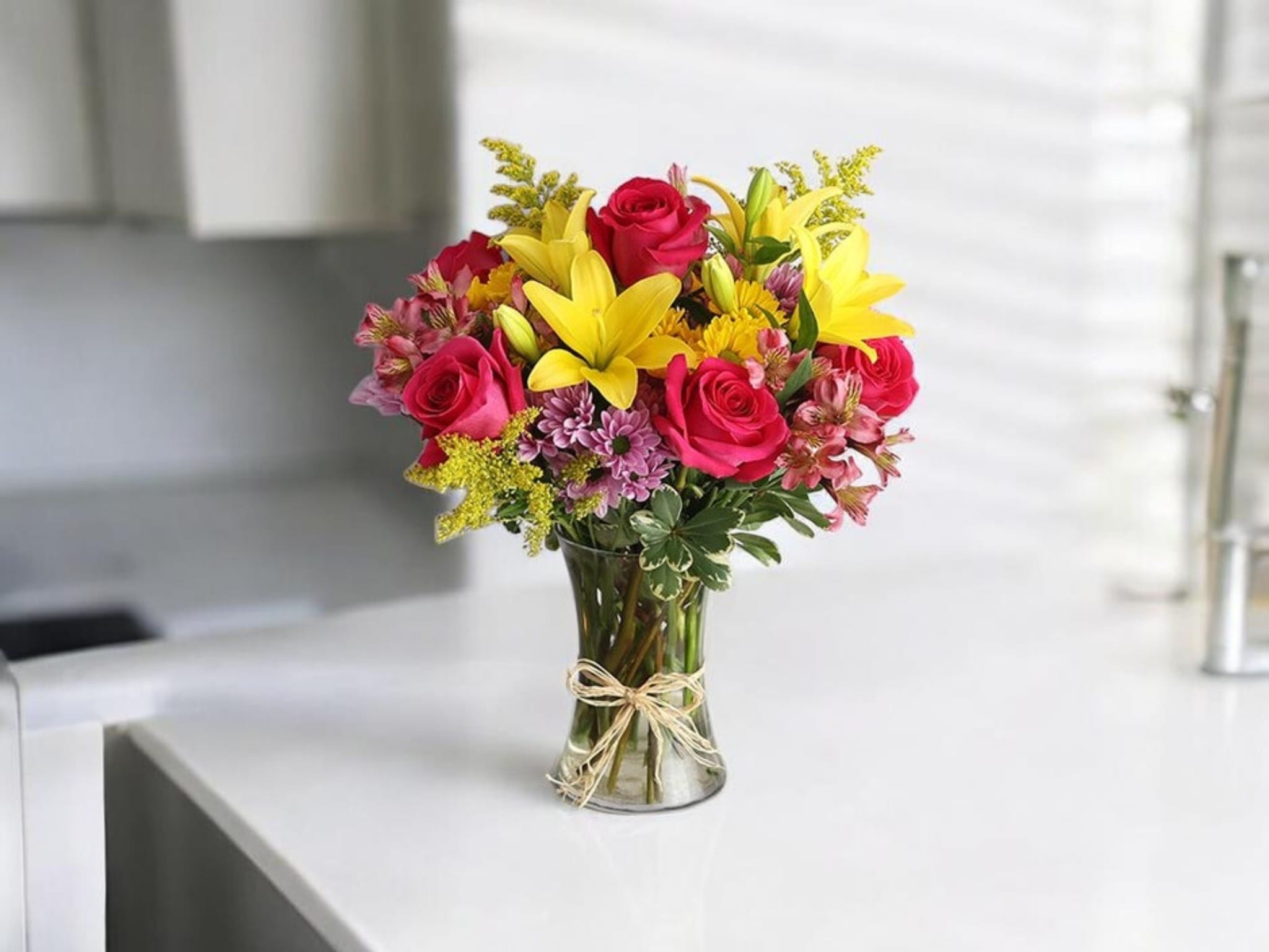 Sunshine &amp; Roses Bouquet - cheerful mix of radiant yellow lilies and vibrant roses, accented with soft seasonal blooms and lush greenery. This bright arrangement brings joy and warmth—perfect for celebrations, thank-you gifts, or uplifting any space.