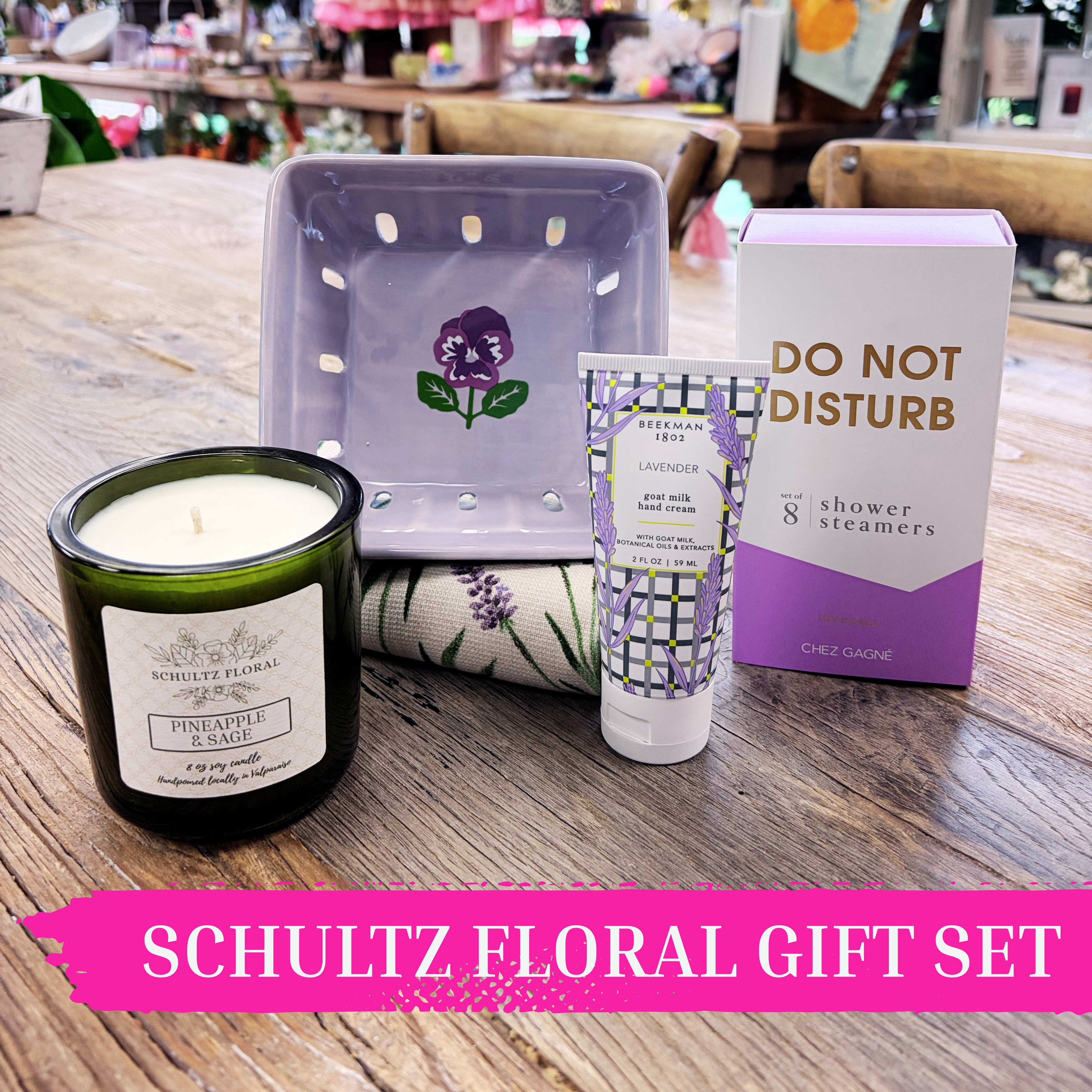 Lavender Self Care Gift Set | Relaxation Gift Set for Her by Schultz Floral - Soft, calming, and thoughtfully gathered, this lavender-inspired gift set is designed for moments of rest and reset. Layered in soothing purples and gentle florals, this collection brings together everyday luxuries with a wholesome, self-care feel. From slow mornings to quiet evenings, each piece invites her to unwind.  Inside you’ll find: – Lavender Goat Milk Hand Cream by Beekman 1802 (2oz) – A ceramic purple pansy berry basket (perfect for display or fresh picks) – A soft lavender tea towel – “Do Not Disturb” lavender shower steamers for an at-home spa moment (set of 8) – Our hand-poured Pineapple Sage candle (8 oz), made locally in Valparaiso  Designed to be gifted for birthdays or simply “thinking of you,” this set is a beautiful way to send calm, comfort, and care.  Available for Valparaiso pickup and local delivery.