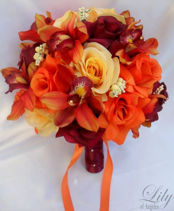Orange and burgundy bouquet with roses and orchids, tied with ribbon