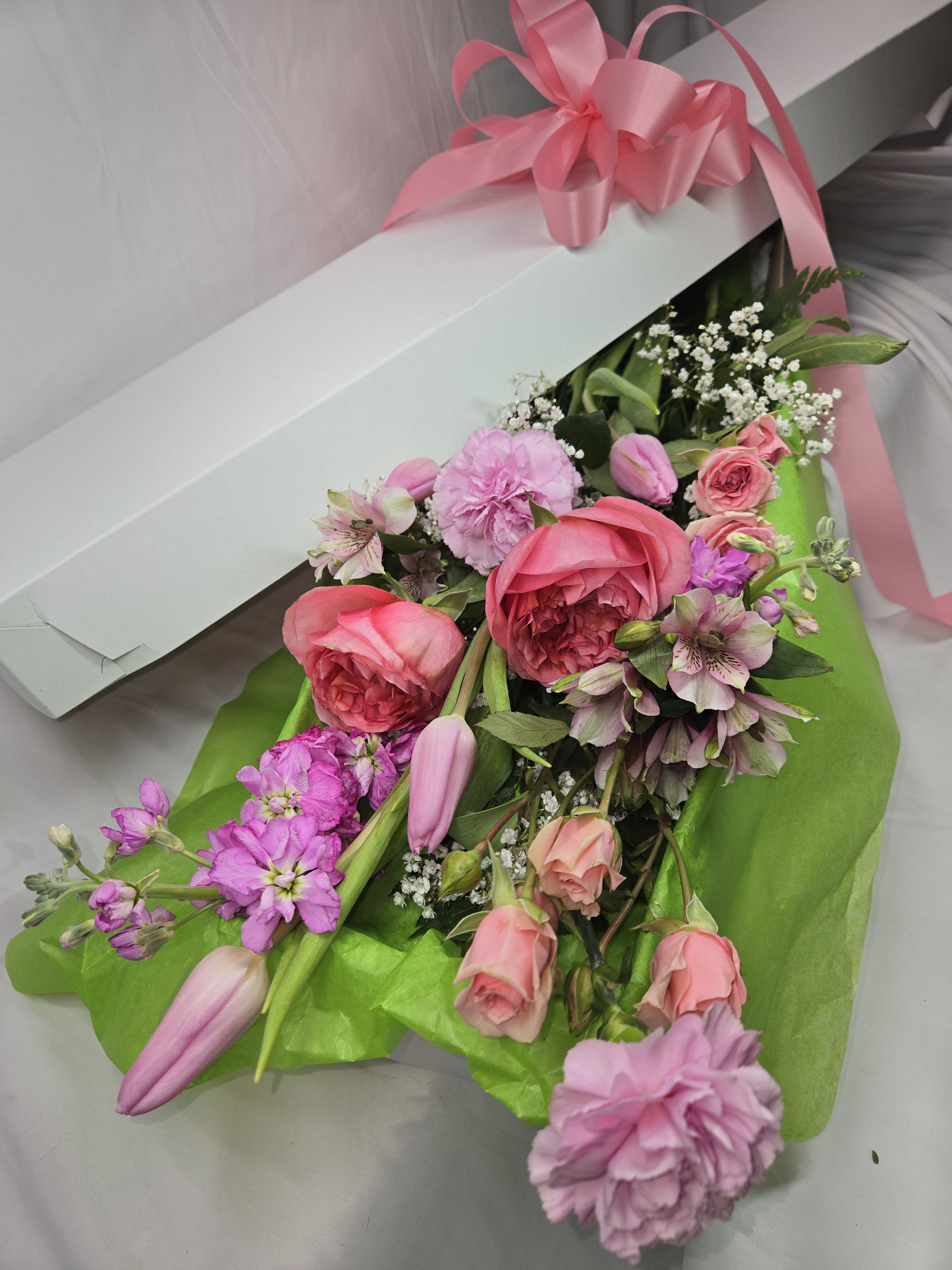 Pink and lavender bouquet in a white box with a pink ribbon