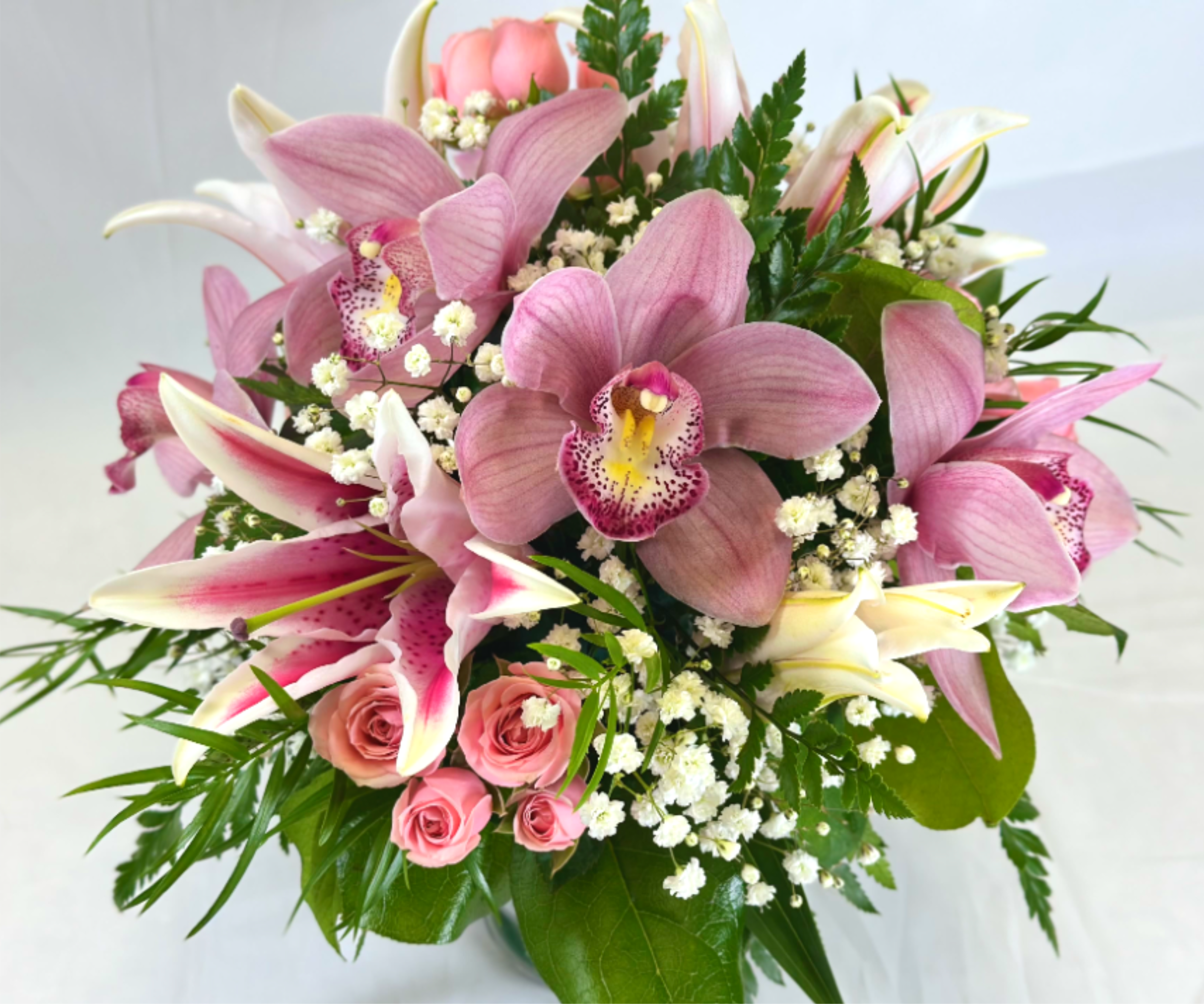The Luxury of Love - This stunning Leary's Flowers exclusive arrangement will be sure to impress, featuring Lilies, Cymbidium orchids, and delicate spray roses. This would be perfect for Valentine's Day,  or Mother's Day, and would also make an elegant sympathy statement.  If the featured flowers are unavailable we will design your gift using the freshest blooms of equal or greater value