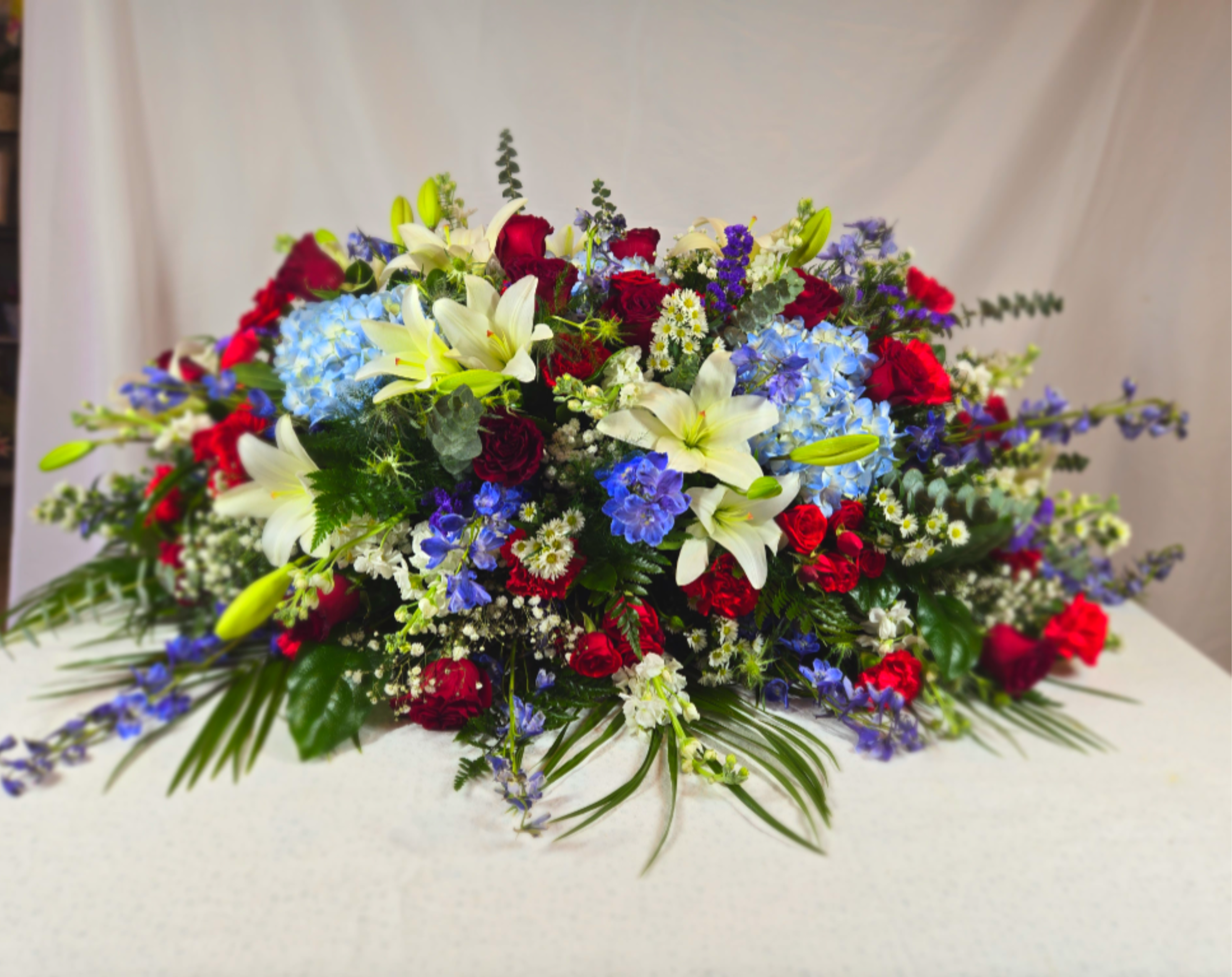 Thank You for Your Service Casket Spray - Honoring someone who has served our country is a passion for us. We have designed  this casket spray as a way to thank your loved one who fought for us all. The red, white, and blue palette help revere the flag, and acknowledges the armed forces in a beautiful way.