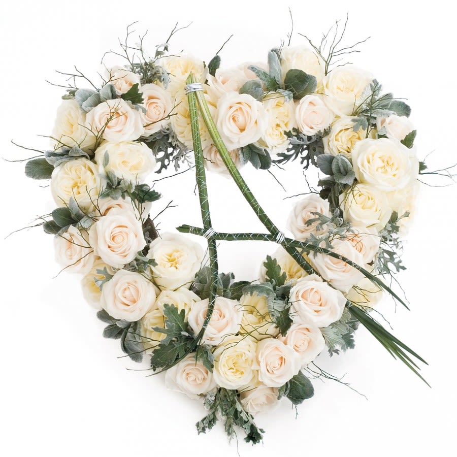 Heart-shaped bouquet of cream roses with muted greenery