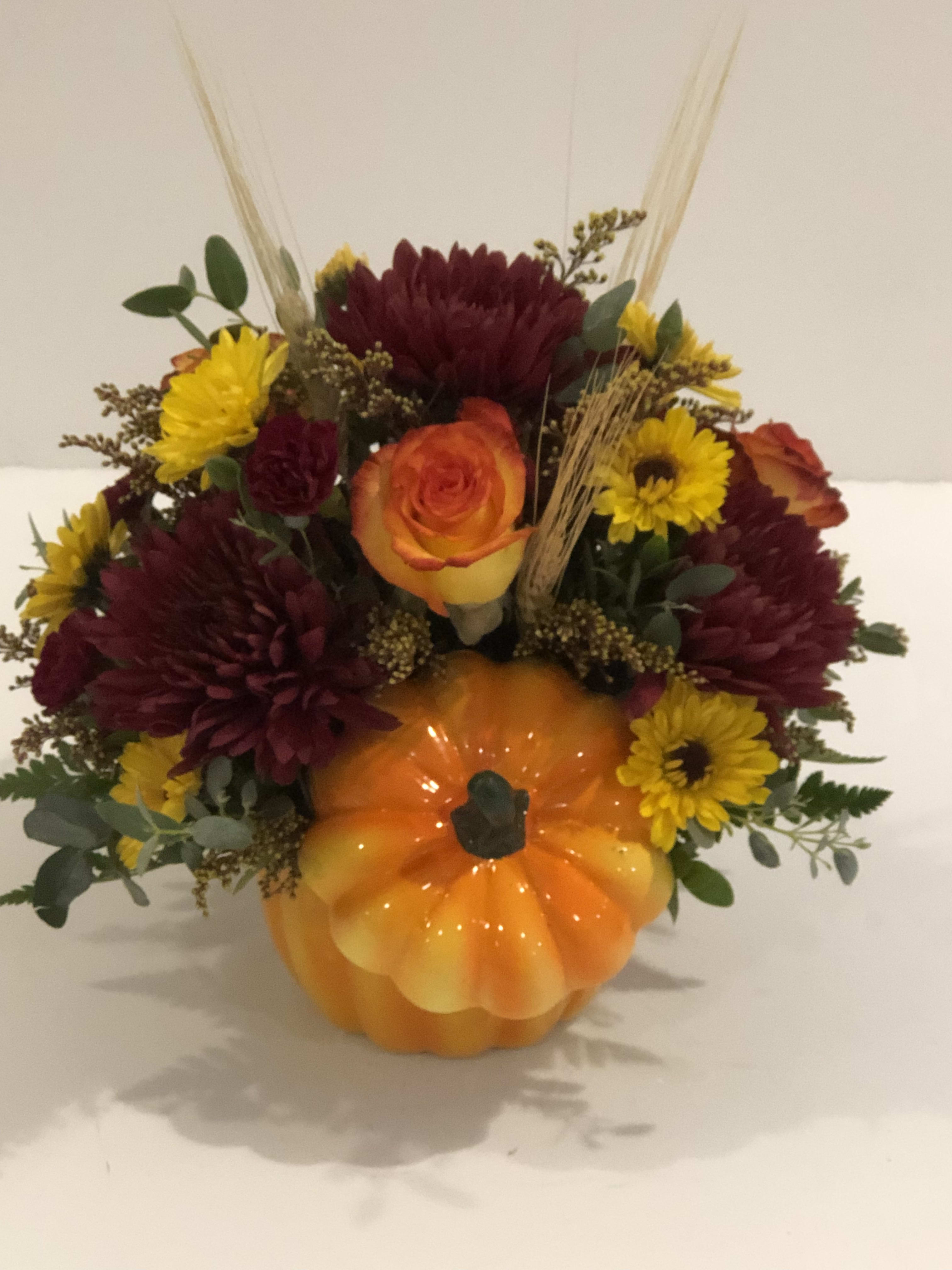 Orange Pumpkin Pot - Beautiful assortment of fresh flowers beautifully designed in a pumpkin keep sake container. Perfect as a thankful holiday gift.