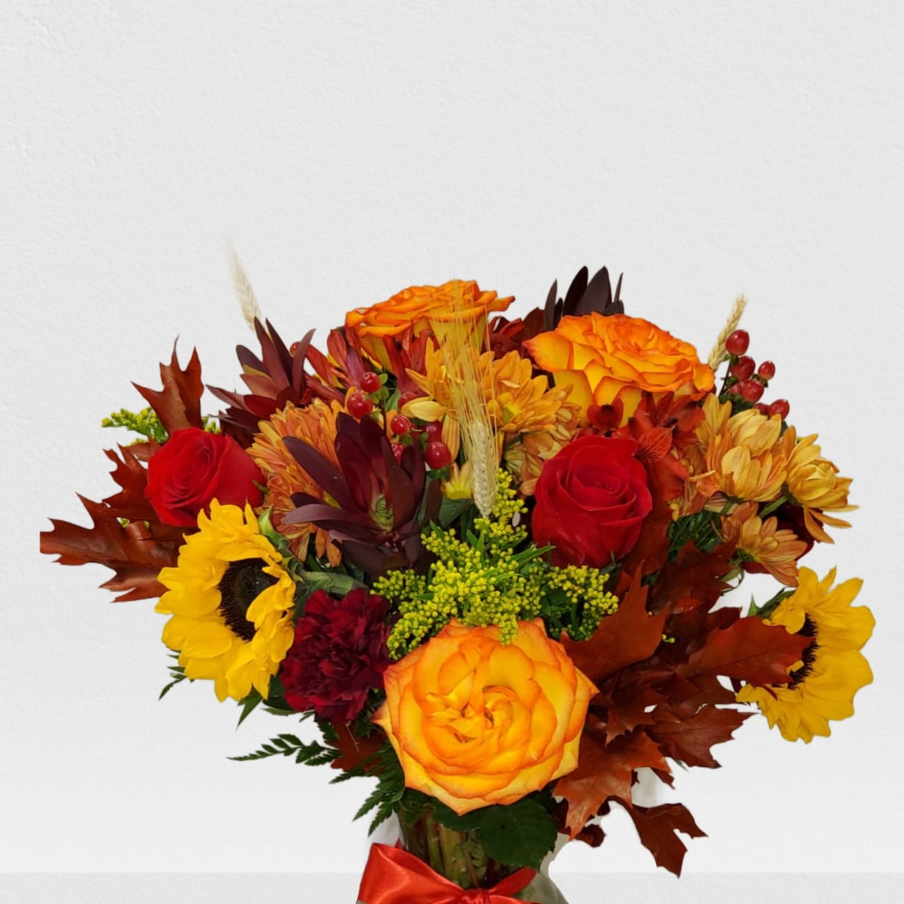 Autumn bouquet with red and orange roses, sunflowers, and mums