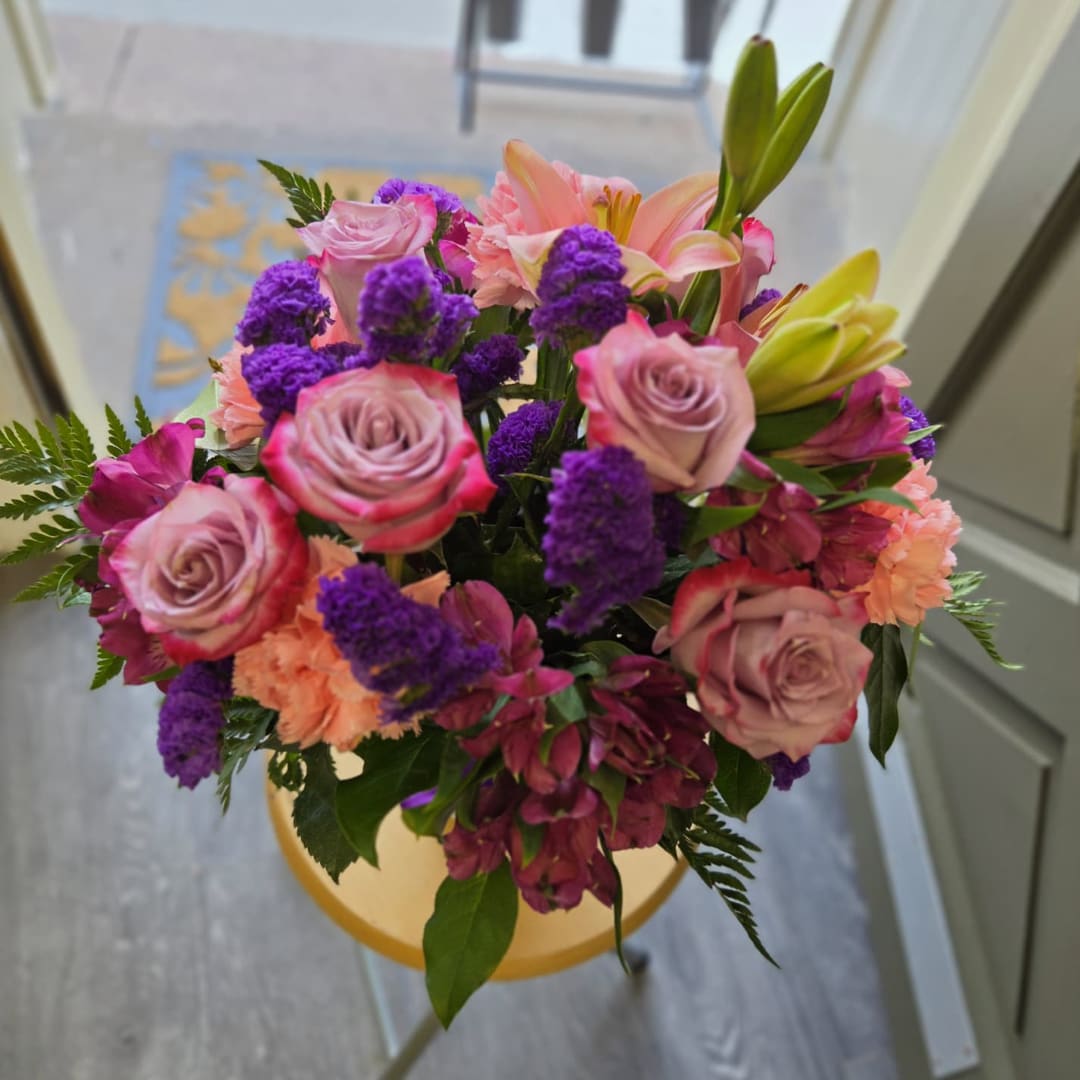 Bouquet of pink roses, lilies, and purple flowers
