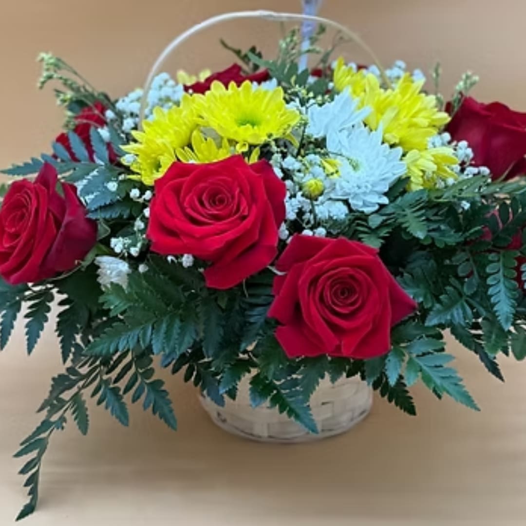 Basket arrangement of red roses and yellow daisies with white filler flowers