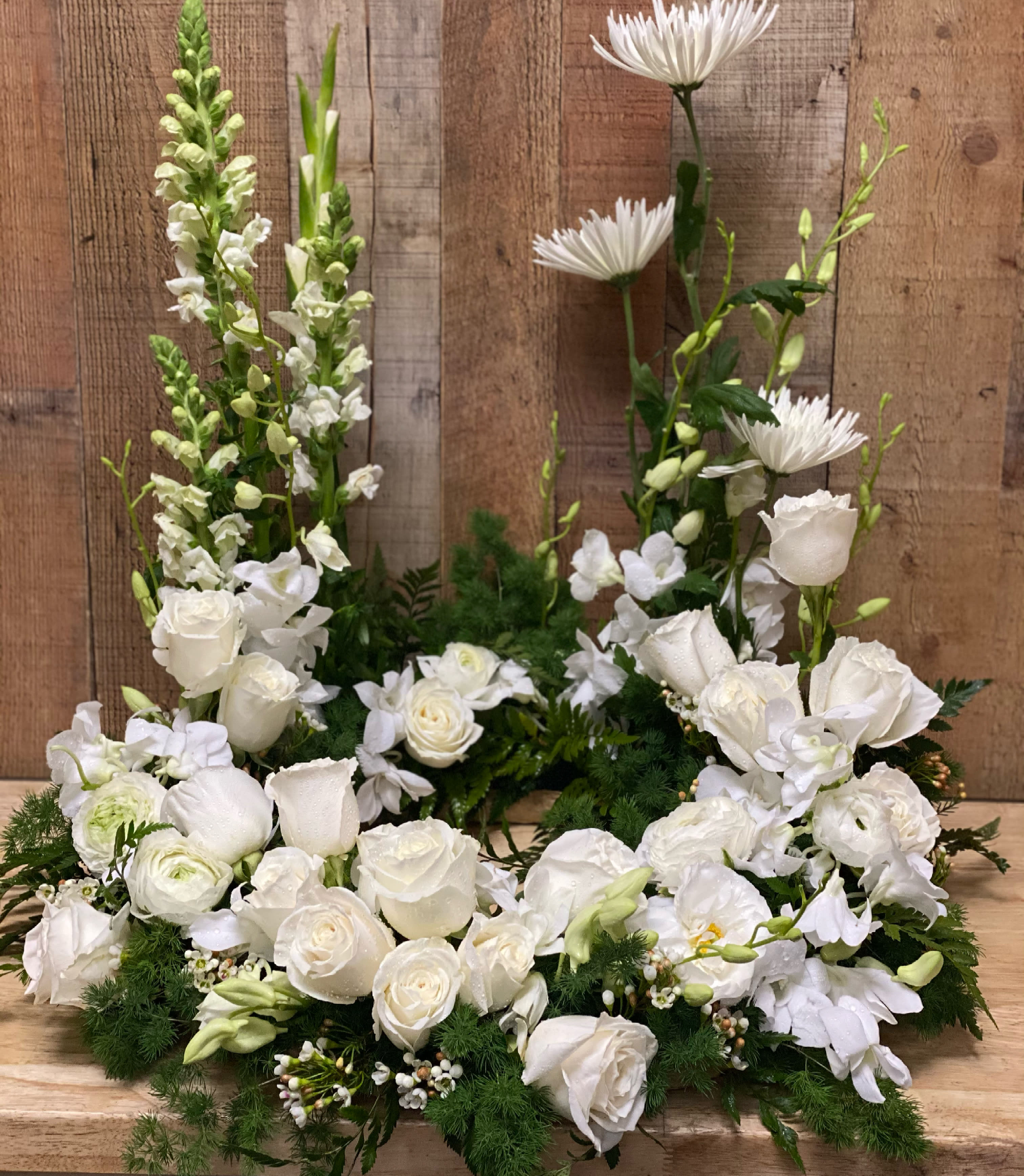 Urn spray  - Mix all white flowers roses orchids mums and more   If you want we can add any color you like 