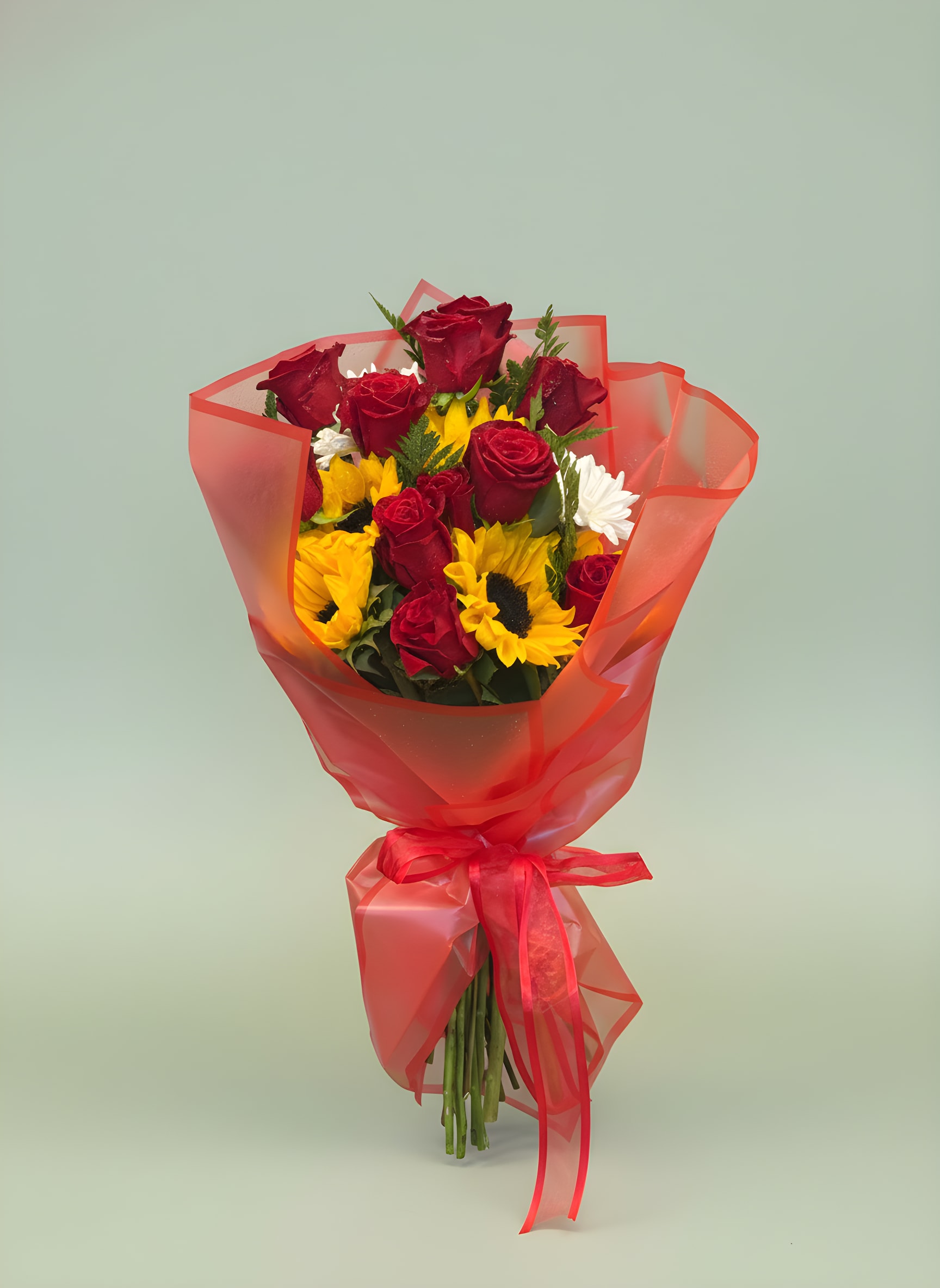 Sunflower &amp; Rose Hand-Tied Bouquet - Bright, cheerful, and full of love, our Sunflower &amp; Rose Hand-Tied Bouquet combines vibrant golden sunflowers with luxurious red roses to create a stunning floral gift for any occasion. Wrapped in elegant red presentation paper and finished with a coordinating ribbon, this bouquet symbolizes happiness, admiration, passion, and joy.  Perfect for birthdays, anniversaries, congratulations, graduations, get-well wishes, or simply brightening someone’s day, this handcrafted bouquet delivers a beautiful message of love and sunshine.  Designed fresh by Tommy Austin Florist using premium flowers, this bouquet is a customer favorite for those looking for a unique and unforgettable floral gift.  Features  * Premium red roses * Fresh golden sunflowers * Seasonal white accent flowers * Decorative hand-tied presentation wrap * Perfect for birthdays, anniversaries, and celebrations * Designed fresh by Tommy Austin Florist