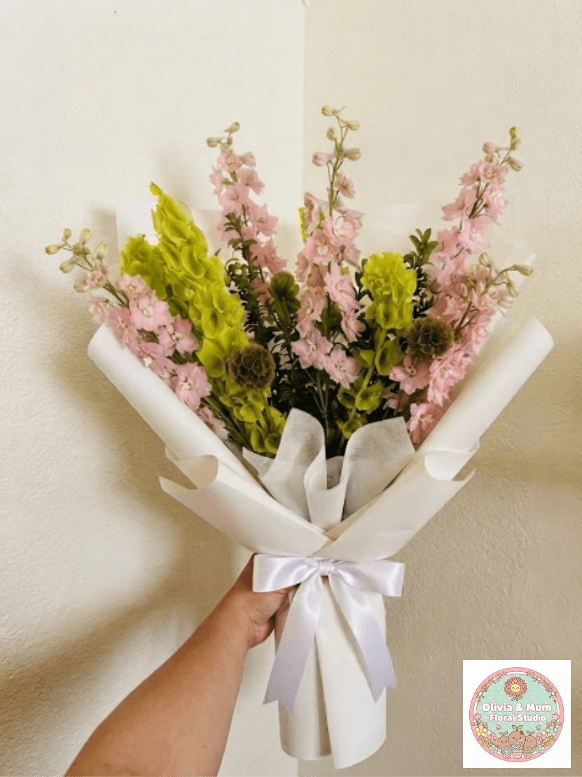 Earth Pink Sky - Grounding, organic, and respectful—Earth &amp; Sky honors a deep connection to the nature. Earthy scabiosa and architectural bells of Ireland create a unique, understated tribute for a memorial or home delivery.  This seasonal bouquet features:  Brown Scabiosa Pods  Bells of Ireland  Fresh Boxwood  Garden Greens  Presentation: Expertly wrapped in our signature textured paper and tied with satin ribbon. Prefer a vase? Add one to your cart to complete the look.  Personal Touch: We’ll include a custom card message with every order. You’ll be able to write your message at checkout.  Please Note: All flowers are subject to seasonal availability. If a specific bloom isn’t available, our designers will thoughtfully substitute with flowers in a similar shape, style, and color.  Standard size shown. Vase upgrade is optional.   Floral Care Guide  Your arrangement arrives in our signature "double wrap" and is nestled in a protective box. While the stems are secured with a wet wrap for transit they are ready for a full drink!   Unpack: Gently lift the bouquet from the box. Remove the plastic bag and wet towel from the stems. Trim &amp; Hydrate: Trim 1/2" off stems at an angle and place in a clean vase with cool water. Refreshed: Change water daily for a long-lasting bloom.  