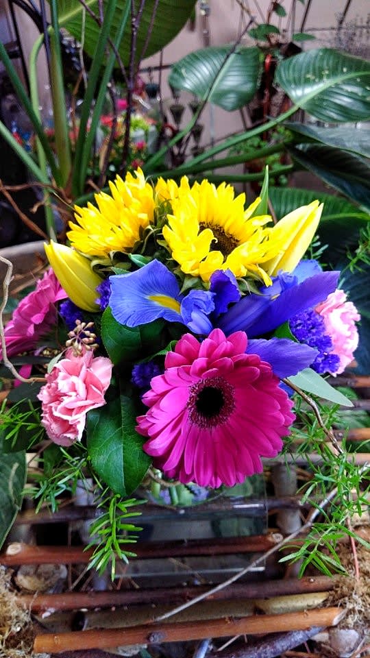 Bright mixed bouquet with sunflowers, gerbera daisies, irises, and carnations