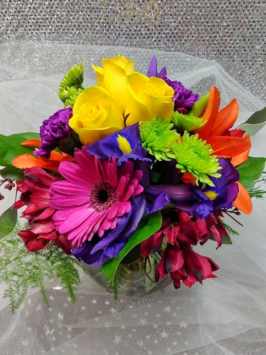 Colorful bouquet with yellow roses, gerbera daisies, and purple flowers