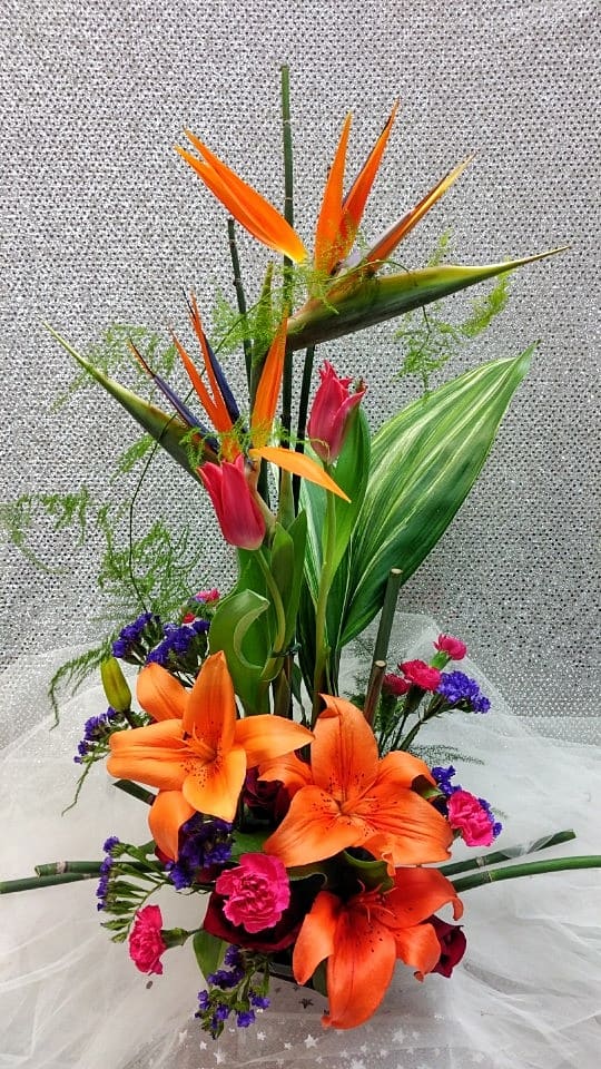 Tall tropical bouquet with orange lilies and pink tulips