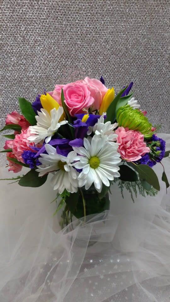 Bouquet of pink roses, white daisies, and colorful mixed flowers