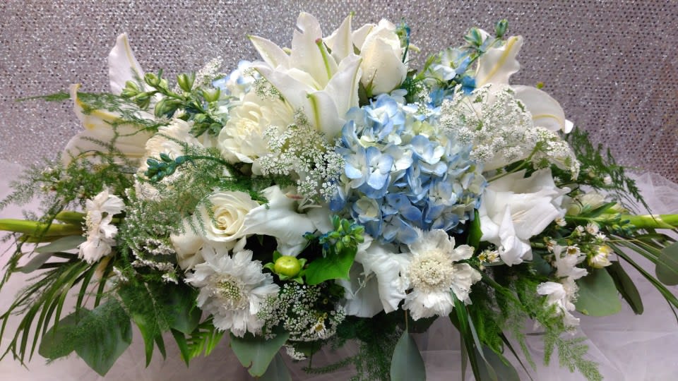 White and blue floral arrangement with lilies and hydrangeas