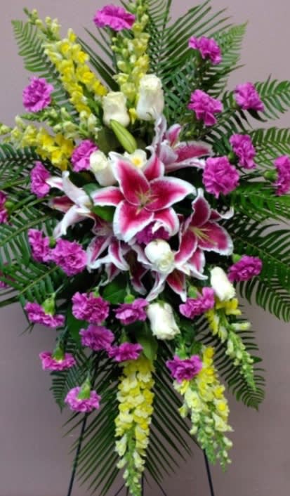 Standing floral spray with pink lilies and purple carnations