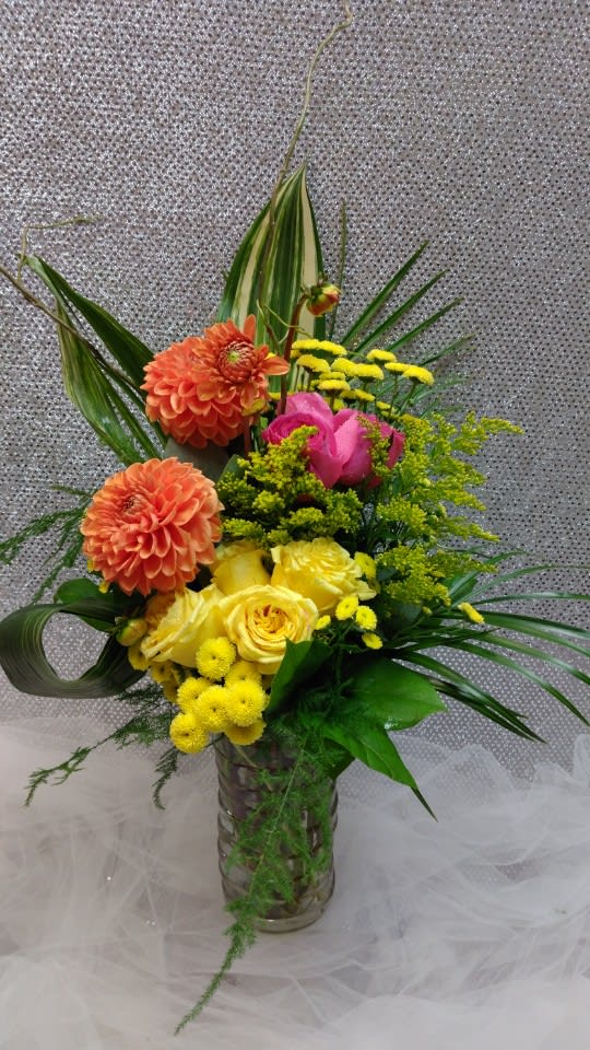 Colorful mixed flower arrangement in a glass vase