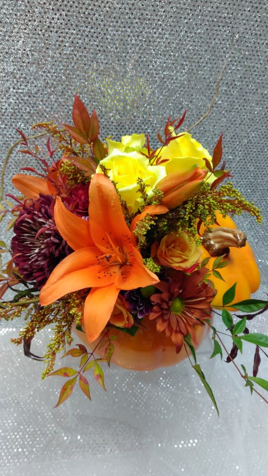 Bouquet of orange lilies, yellow roses, and dark mums