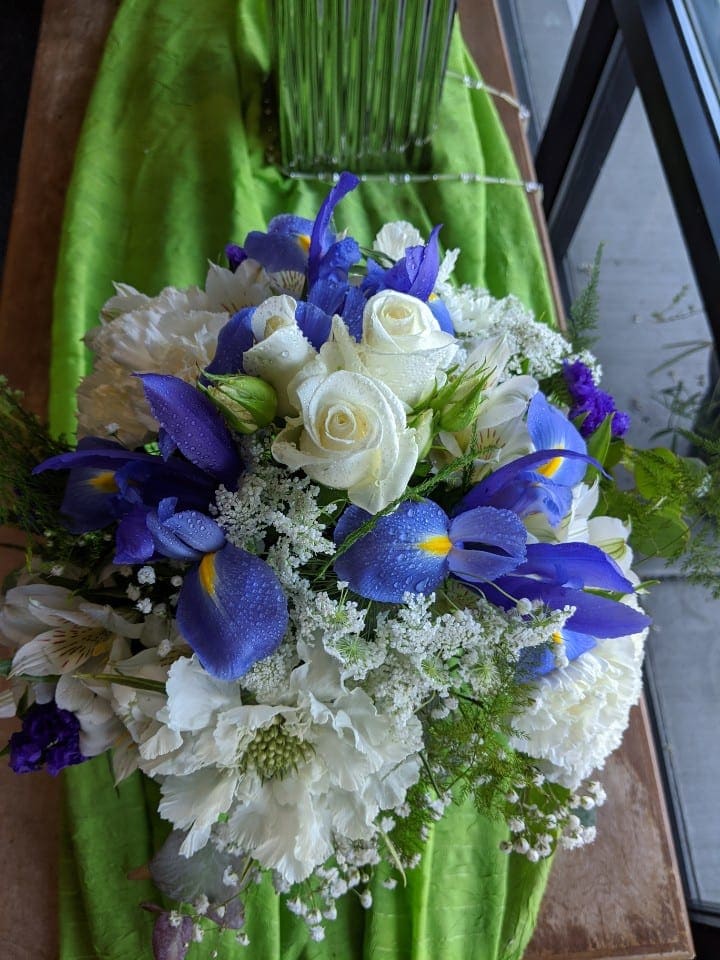 Classical Summer  - One of our popular rose vase arrangements, designed beautifully with roses, iris, carnations, status, queen anne's lace, baby's breath, alstroemeria, and various filler greens. Dimension: 14"x12"