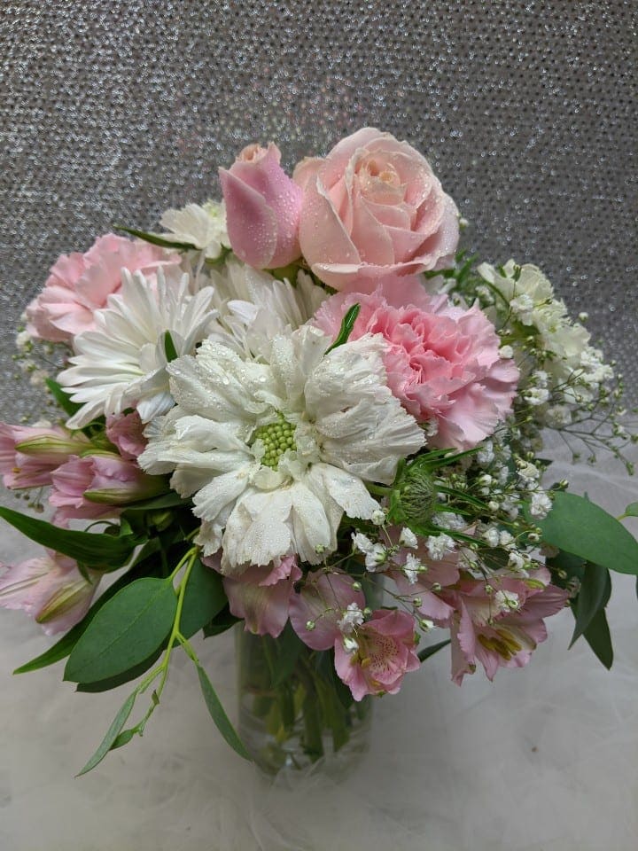 Pink and white bouquet in a clear glass vase
