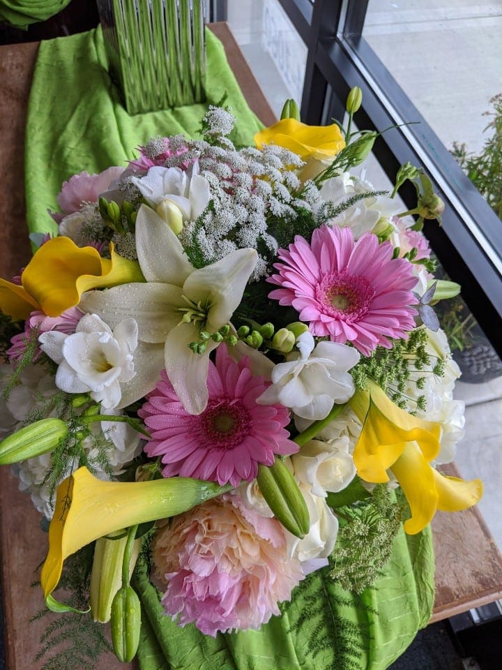 Bouquet of pink gerbera daisies, white lilies, and yellow calla lilies