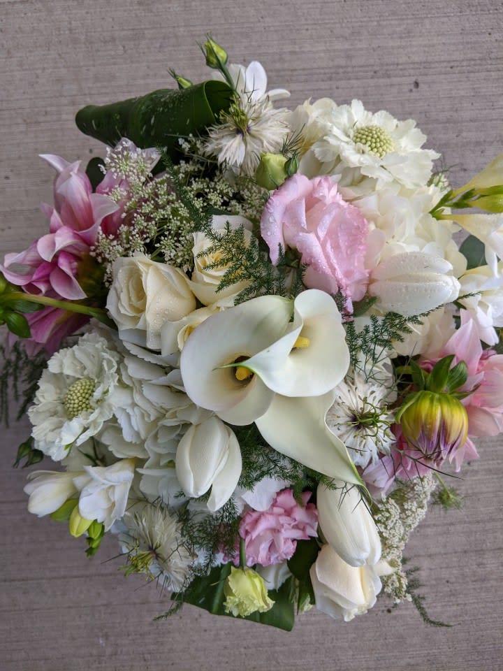 Bouquet of white calla lilies, roses, and pink flowers
