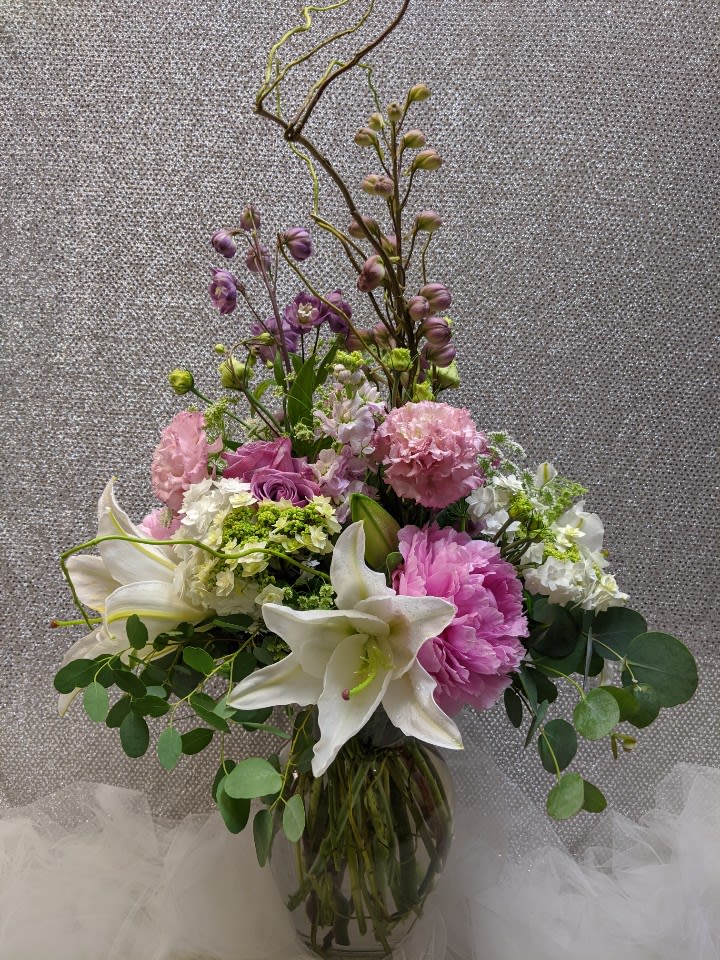 Pink and white floral arrangement in a glass vase