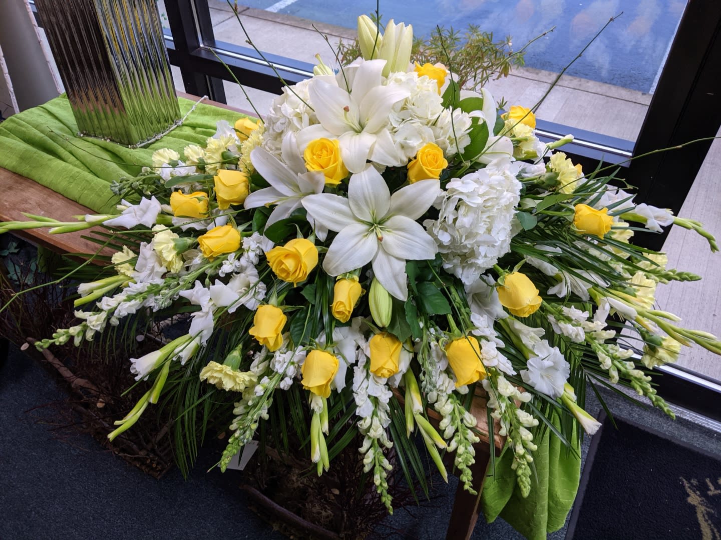 White lilies and yellow roses in a large floral spray