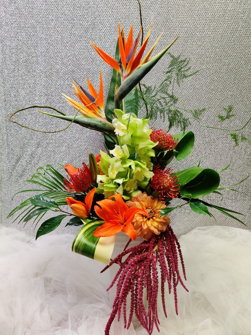 Tall tropical bouquet with orange bird of paradise and orchids