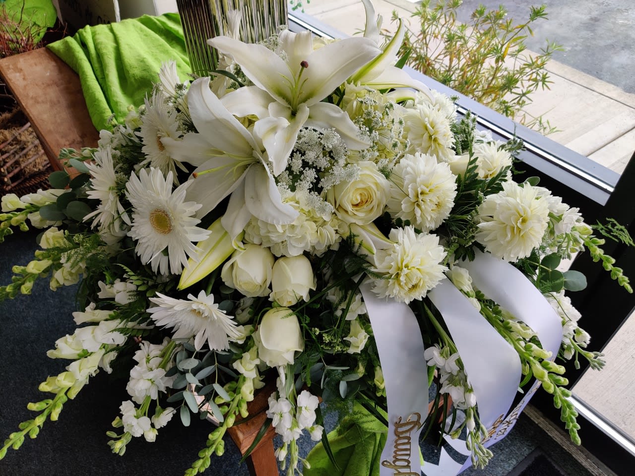 White floral spray with lilies, roses, and daisies