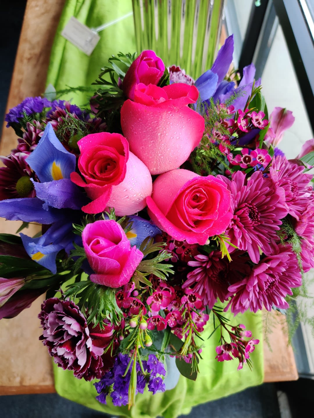 Bouquet of pink roses, purple blooms, and mixed flowers