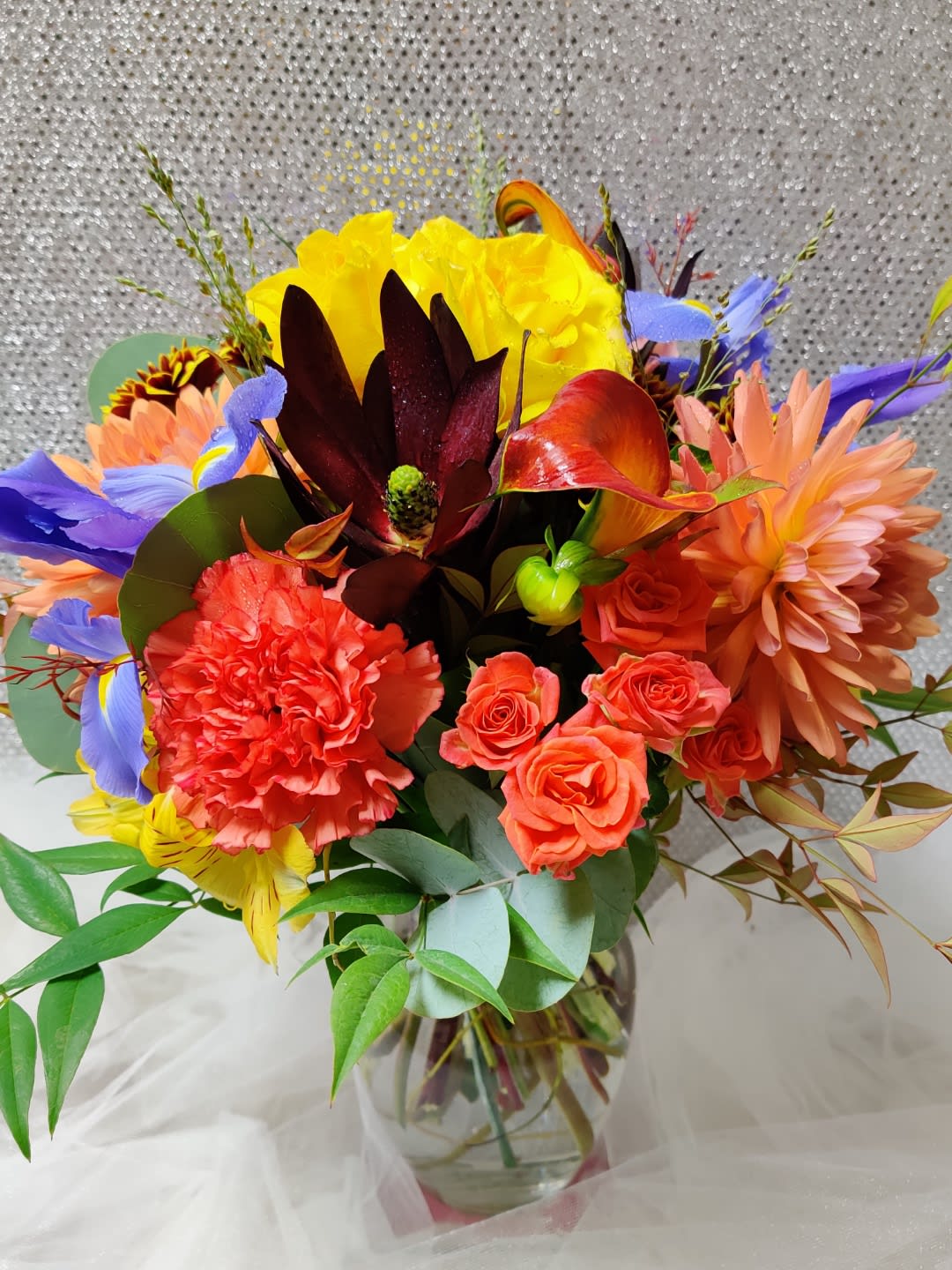 Colorful bouquet of mixed flowers in a glass vase