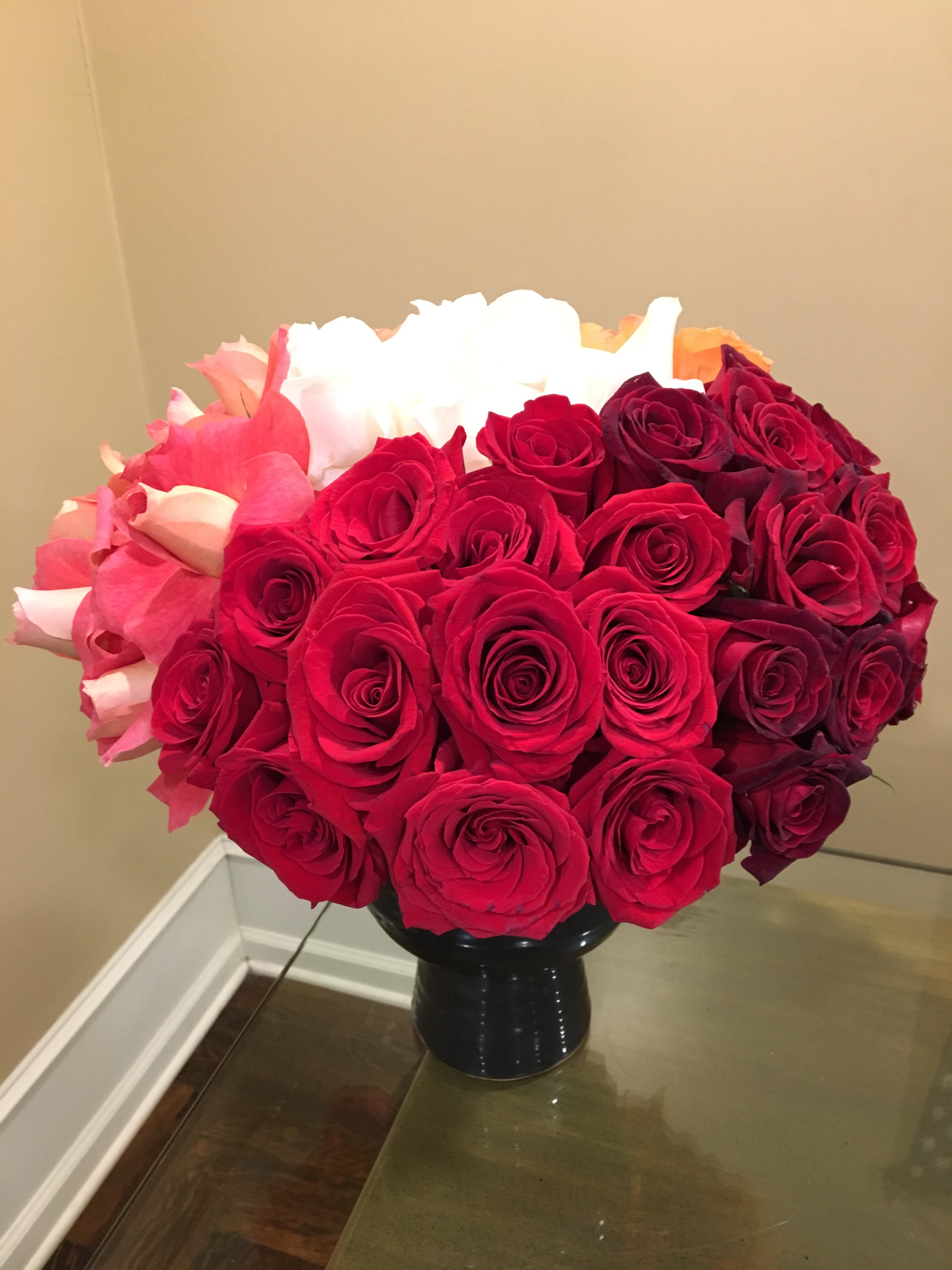 Bouquet of red and pink roses in a black vase
