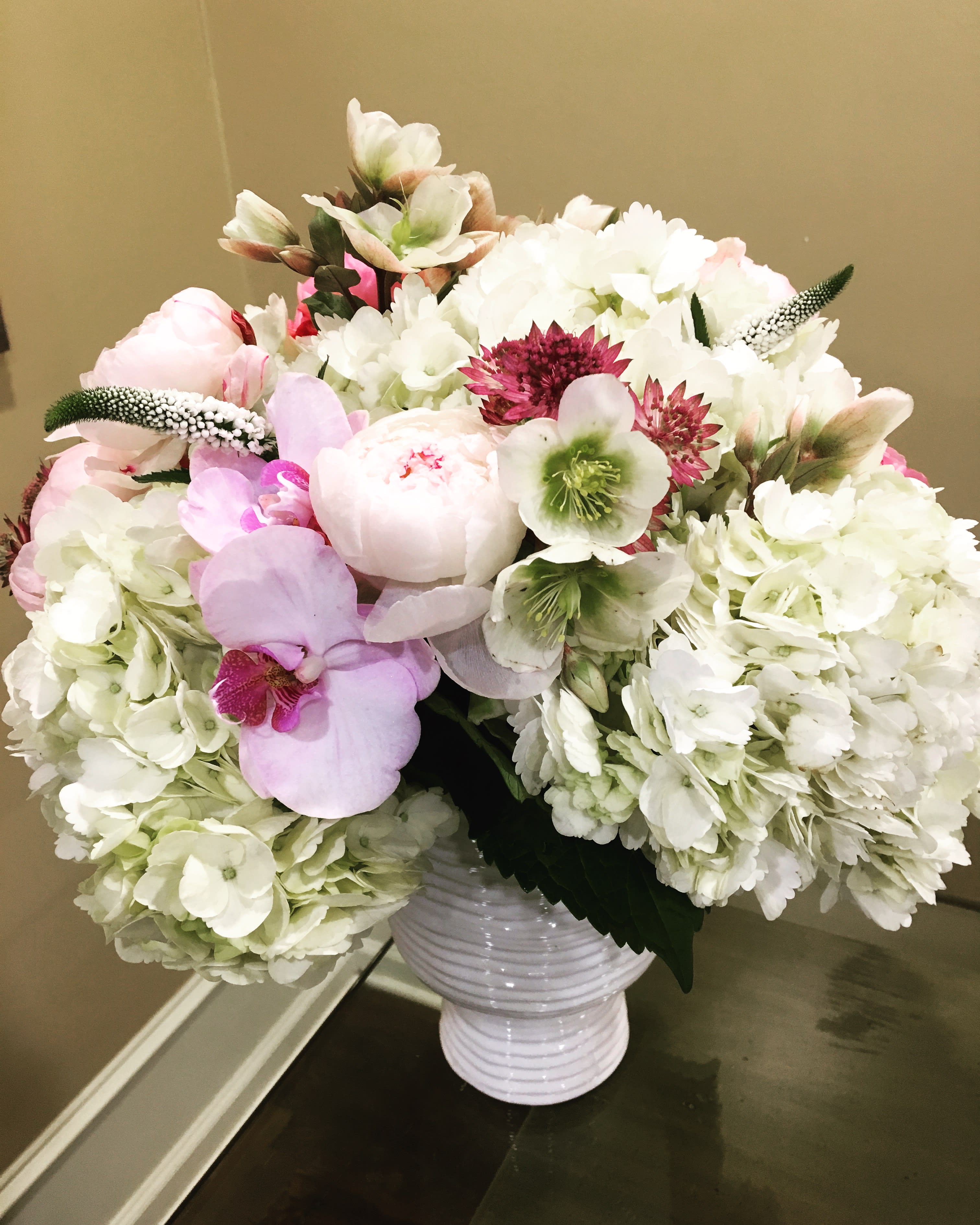 Pale pink and Cream collection: roses, orchids, hydrangeas and other specialty blooms - A lush collection of white hydrangeas with delicate accents of pinks, orchids and other interesting element. Deluxe shown. 