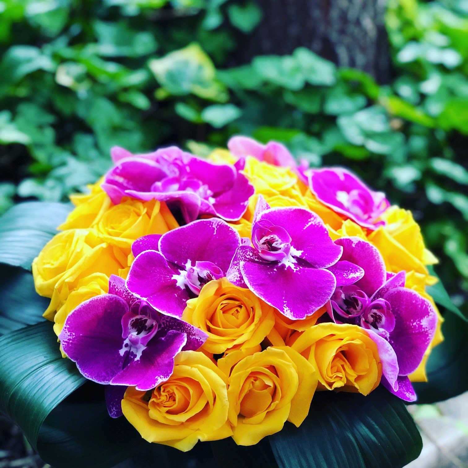 Bouquet of yellow roses and purple orchids