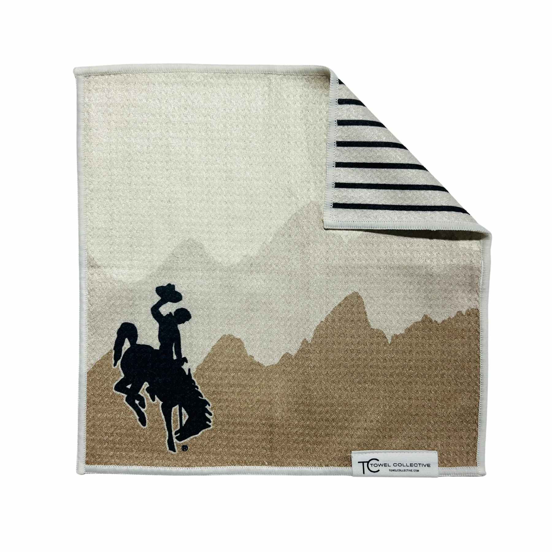 Folded towel with a horse rider graphic and striped corner detail