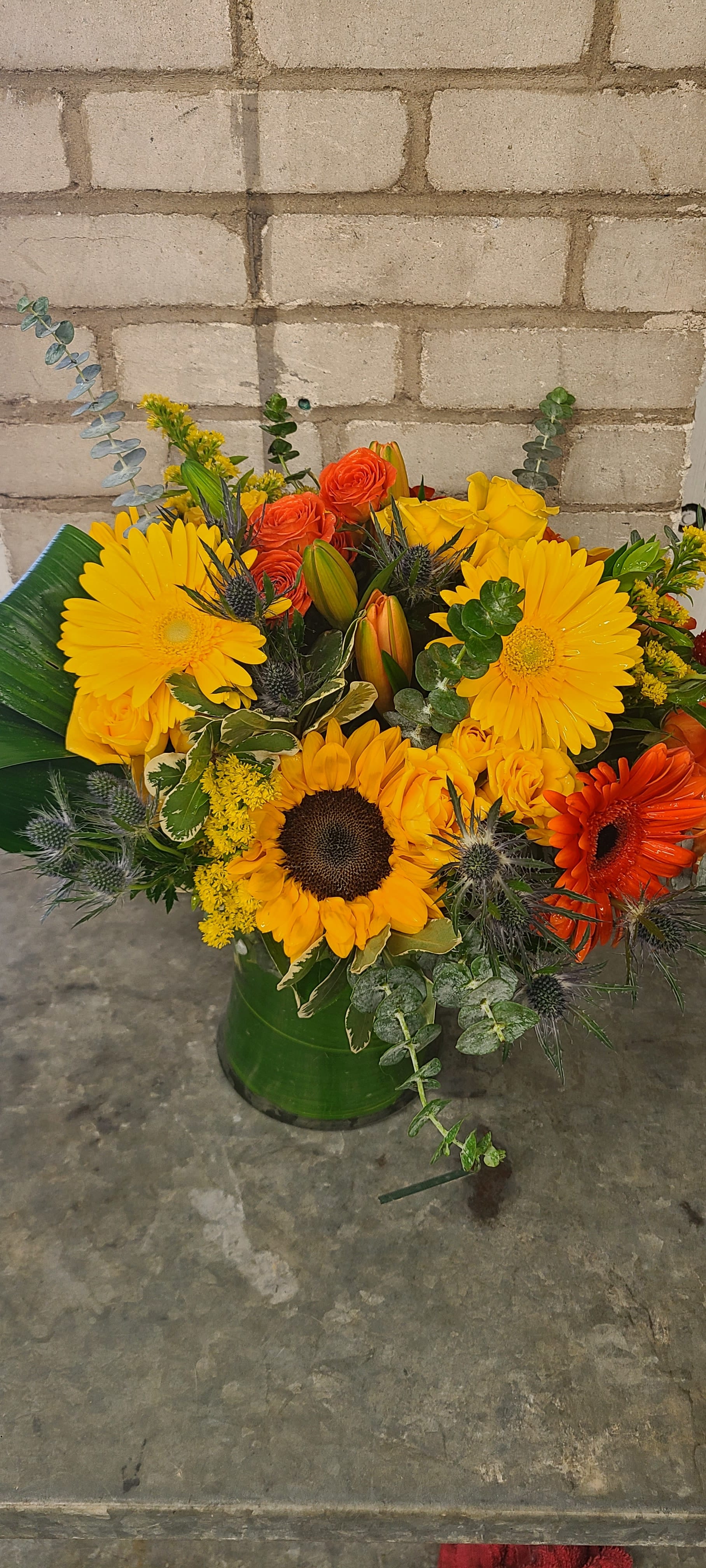 Bright  light By Kokee - A mictures of bright flowers on  gahering  vase with a green leaf decoration inside the vase 