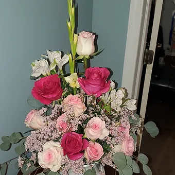 Sympathy urn pink - A beautiful combination of roses, babysbreath, gladiola or larkspur, alstro, and eucalptus in a classic white urn.  