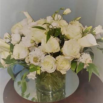 Ultra Posh - Park ave comes to Long Island, with this beautiful all white luxury arrangment.  Made with all high end flowers, garden roses, calla lily, lisianthus, campanula, and scabiosa.  Its a stunner!