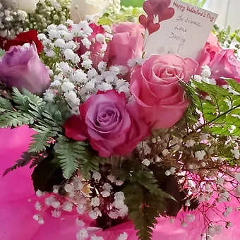 little sweetheart arrangement - 6 colorful roses, vased with babysbreath and leatherleaf greenery.  Perfect for a little princess or prince.