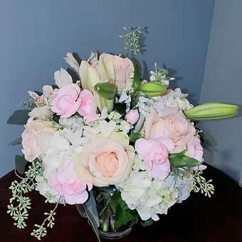 Pink Blush - Soft and delicate arrangment of white hydrangea, light pink spray carnation, pink rose and silvery greenery.
