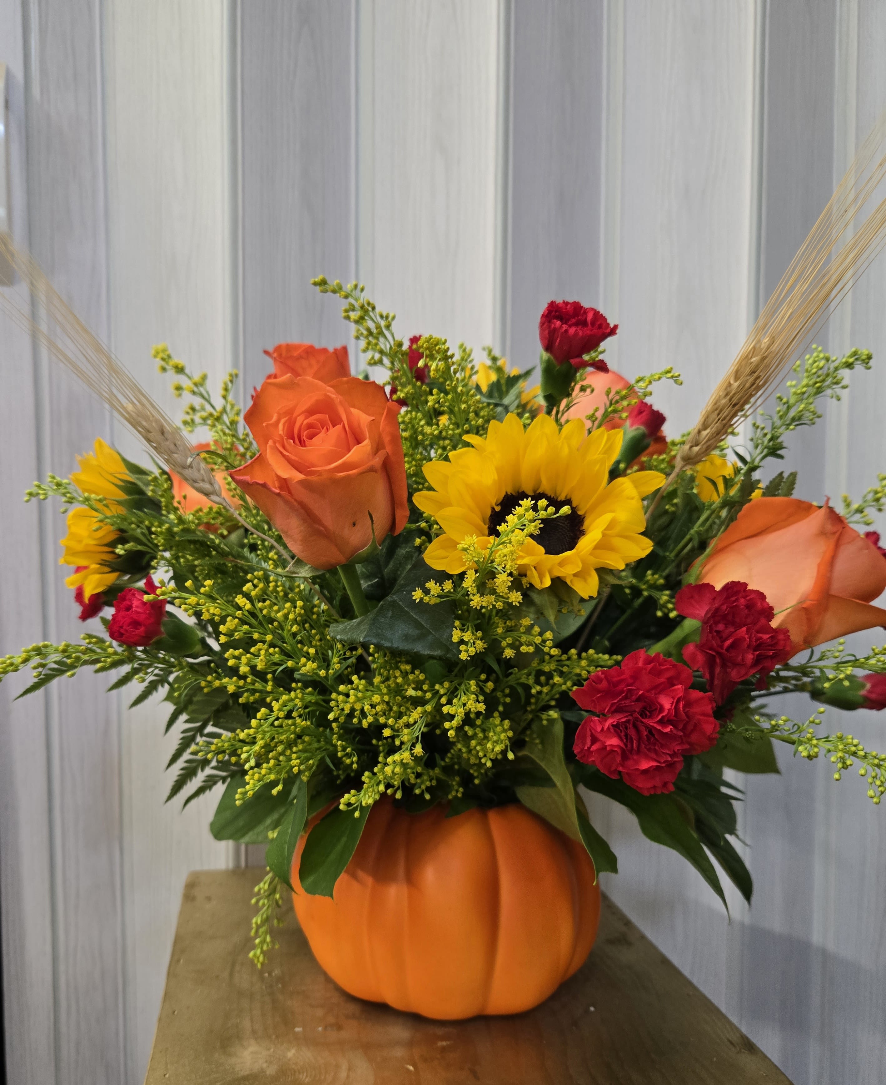Harvest pumpkin bouquet  - Sunflowers, orange roses, red carnations, goldenrod filler, wheat stems.