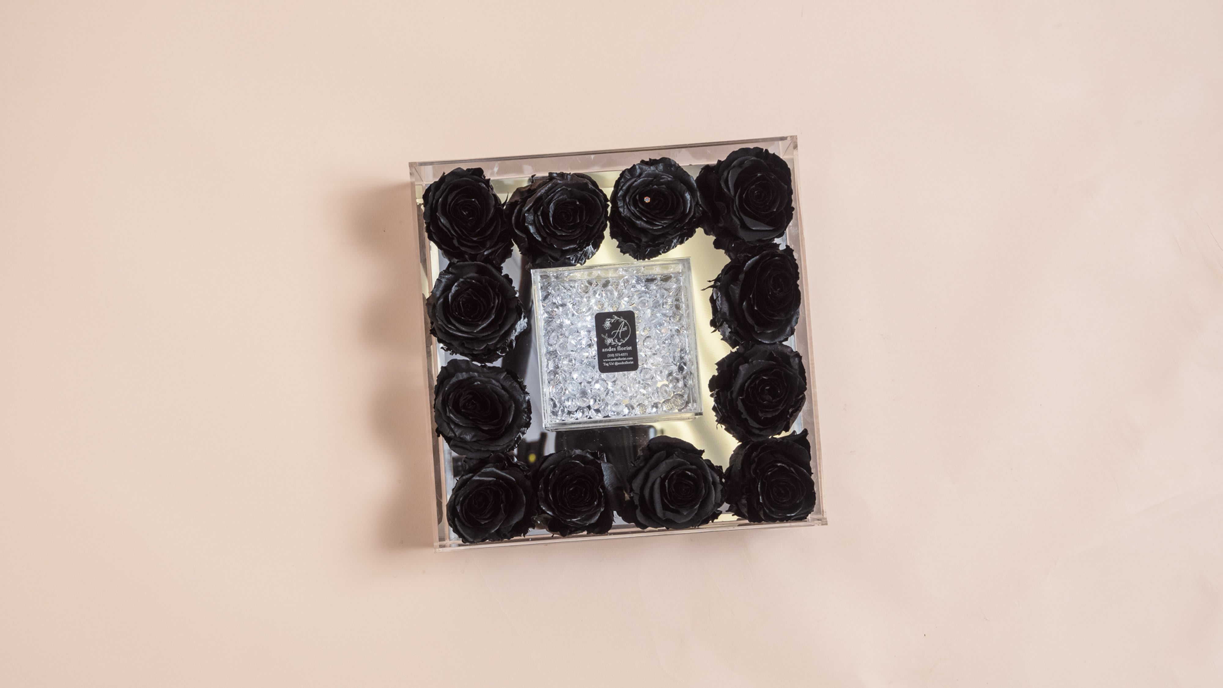 Square box of black roses with a clear jeweled center