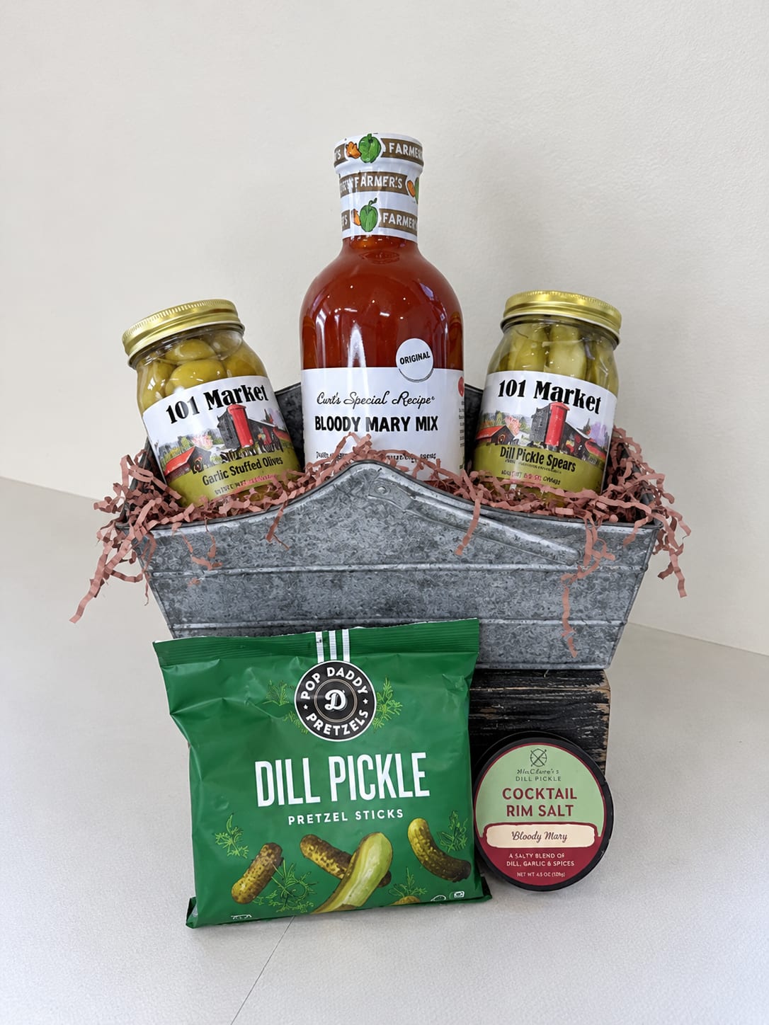 Gift basket with Bloody Mary mix, olives, pickles, pretzels, and cocktail salt