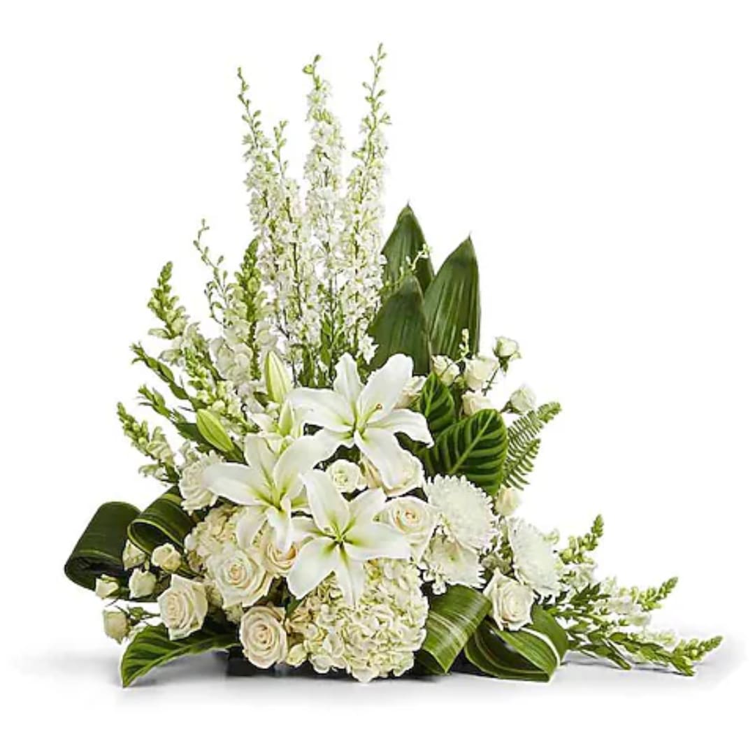 White lilies and roses arranged in a low, lush bouquet