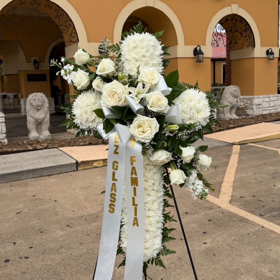 White funeral standing spray with roses and chrysanthemums on a ribboned easel