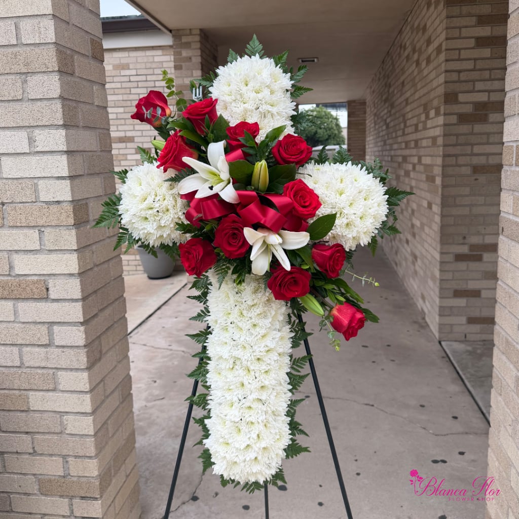 Standing cross arrangement with red roses, white lilies, and white chrysanthemums
