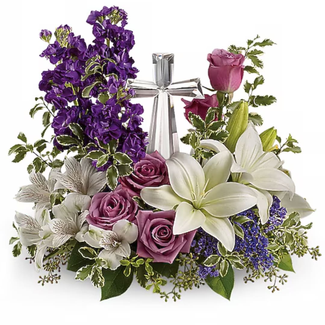 Purple and white floral arrangement with roses and lilies, topped by a silver ribbon