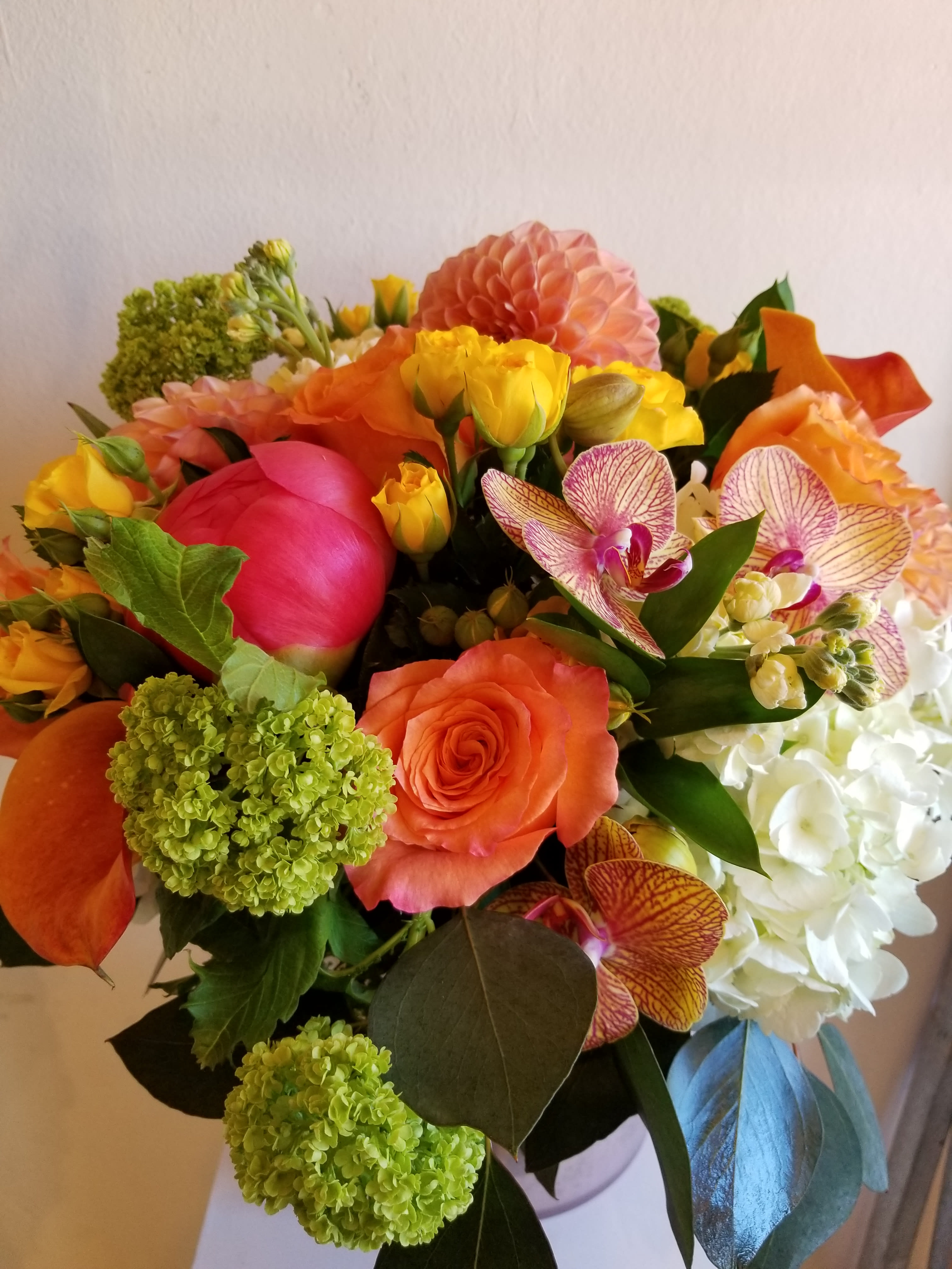 Bright mixed bouquet with orange, pink, yellow, and white flowers